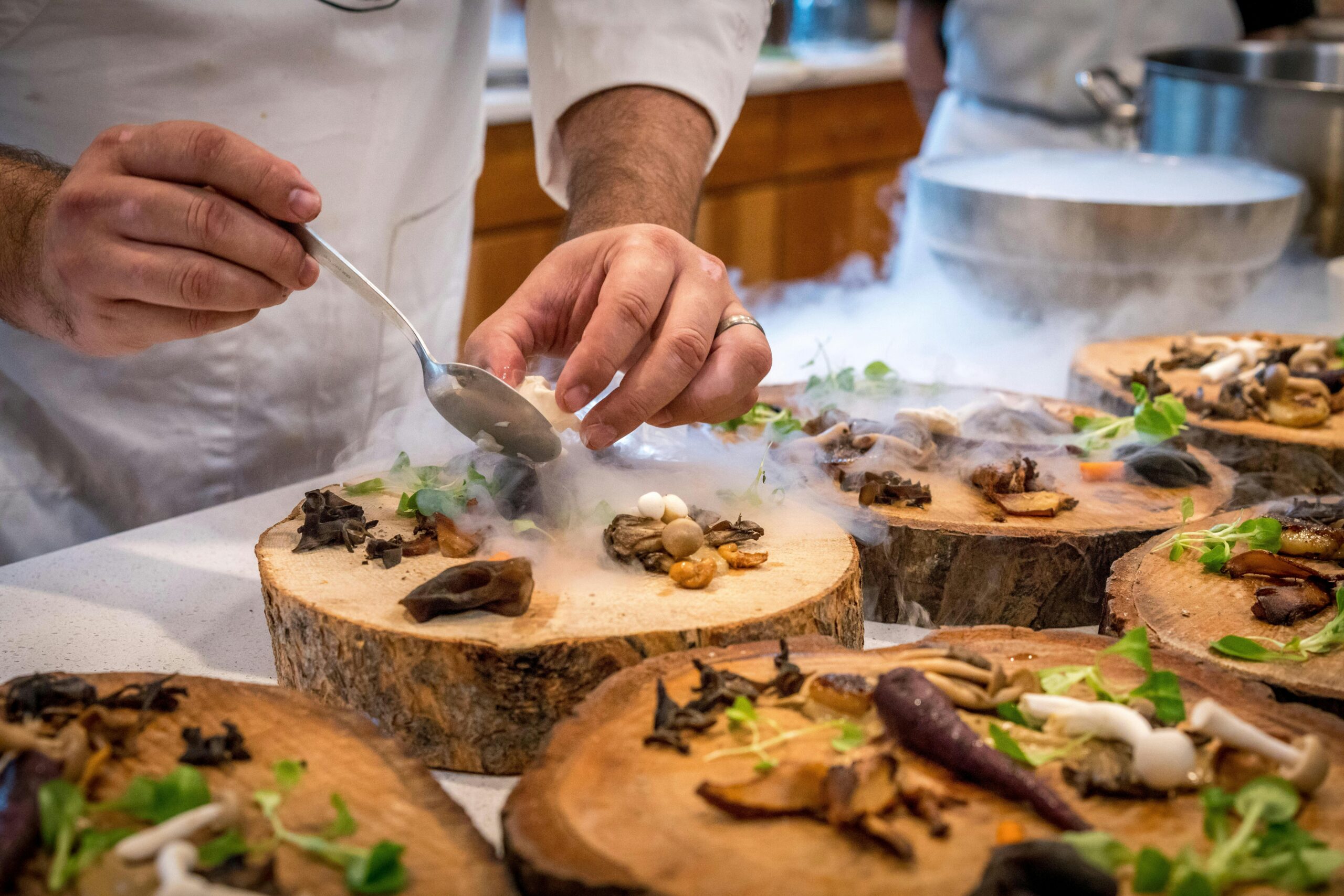 Image of a chef preparing food at a fine dining restaurant.